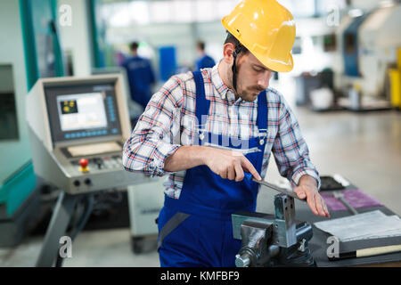 Metal industry factory worker working on metal parts Stock Photo