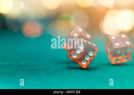 Photo of several red dice falling on green table in casino Stock Photo