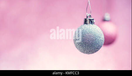 Picture of New Year's pink and gray balls on empty pink background. Stock Photo