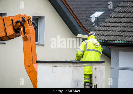 Electrician repairing street lights on a lift Stock Photo