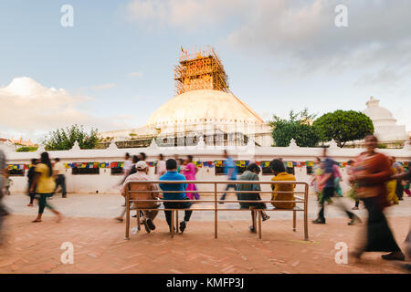 KATHMANDU, NEPAL - 29 AUG 2015: Bystanders take a break during the full moon perambulation around the Boudhanath stupa, in Kathmandu, Nepal. Stock Photo