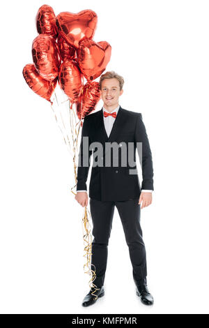 man with heart shaped balloons Stock Photo