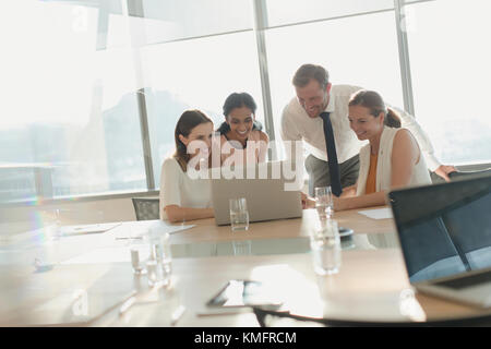 Business people working at laptop in conference room meeting Stock Photo