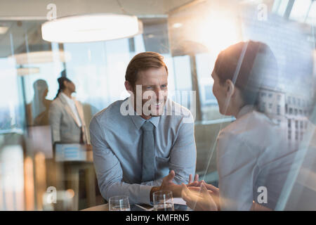 Businessman and businesswoman talking in office Stock Photo