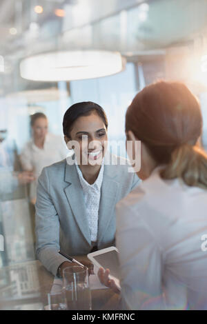 Smiling businesswomen using digital tablets in office Stock Photo