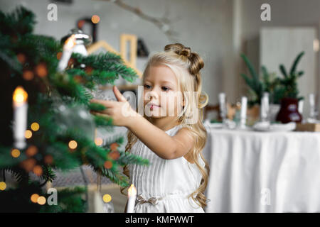 Christmas table: knife and fork, napkin and Christmas tree branch on a wooden table . New Year's decor of the festive table. Christmas background. Stock Photo