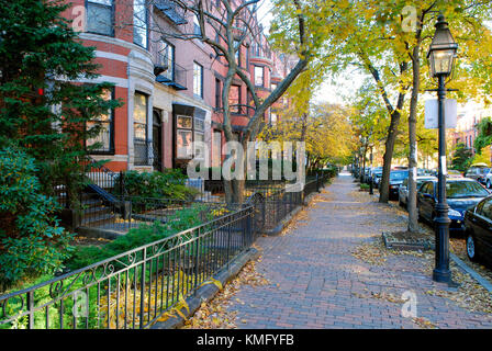 Back Bay Boston in the fall. Victorian townhouses, iron fences, brick sidewalk, street lamps, fall foliage. Stock Photo