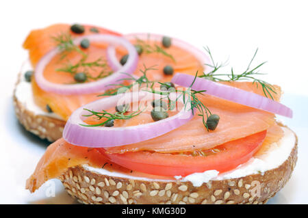 Smoked salmon and sesame seed bagel isolated on white Stock Photo