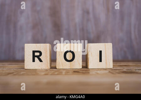 ROI Word on Wooden Blocks - Business and financial concept Stock Photo