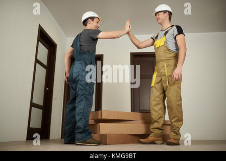 Two workers give high five in successful job Stock Photo