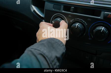 Close-up of man open switch air in car Stock Photo