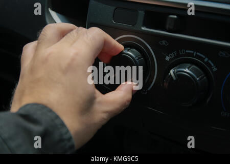 Close-up of man open switch air in car Stock Photo