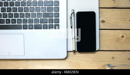 Keyboard With Book and phone on wood background Stock Photo