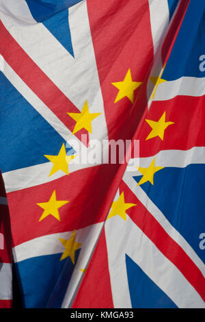 Close up of UK Union Jack with gold stars of European flag superimposed. Flag is 'flapping' with big fold across. Very colourful. Stock Photo