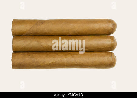 Set of three Cuban luxury cigars rolled from tobacco leaves isolated on white background Stock Photo