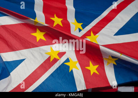 Close up of UK Union Jack with gold stars of European flag superimposed. Flag is 'flapping' with big fold across. Very colourful. Stock Photo