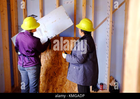 Two women working on a building site in Ontario, Canada. Stock Photo