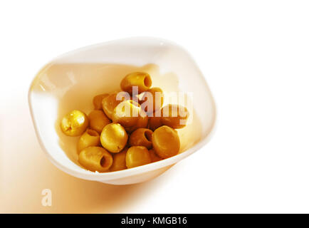 marinated olives in teabowl on white background Stock Photo