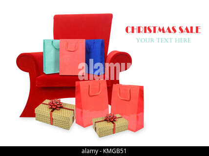 Composite image of a red armchair of Santa Claus with Christmas gifts and copy space (sample text). Stock Photo