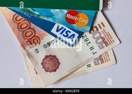 credit and debit cards of international systems Visa and MasterCard over paper banknotes of 5000 rubles. Volgograd region, October 1, 2016 Stock Photo