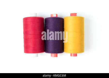 Colored thread coils on a white background, sewing accessories Stock Photo