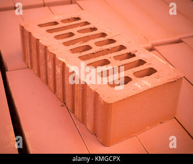 orange clay brick stack, pile. background. Stock Photo