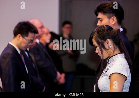 (171212) -- THE HAGUE, Dec. 12, 2017 (Xinhua) -- People mourn in silence for the victims of Nanjing Massacre during a memorial in The Hague, the Netherlands, on Dec. 12, 2017. Some 200 Chinese people and students living in the Netherlands attended a memorial of Nanjing Massacre, held one day ahead of China's 'National Memorial Day for Nanjing Massacre Victims.' (Xinhua/Rick Nederstigt) Stock Photo