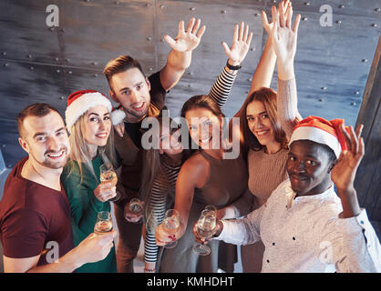 party, technology, nightlife and people concept - smiling friends with  smartphone taking selfie in club. Stock Photo