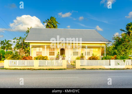 Grand Cayman, Cayman Islands, Nov 2017, Caribbean-style house with a corrugated tin roof and a veranda in George Town Stock Photo