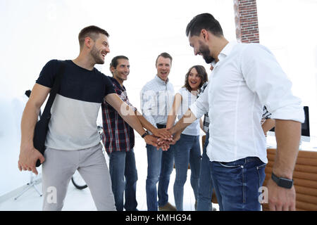 .friendly team of designers clasped their hands together Stock Photo