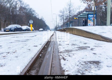 The Hague, the Netherlands - February 11, 2017: snow covered tram rails near a tram stop at Loosduinen, The Hague Stock Photo