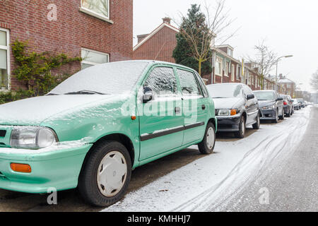 The Hague, the Netherlands - February 11, 2017: cars on street covered in snow Stock Photo