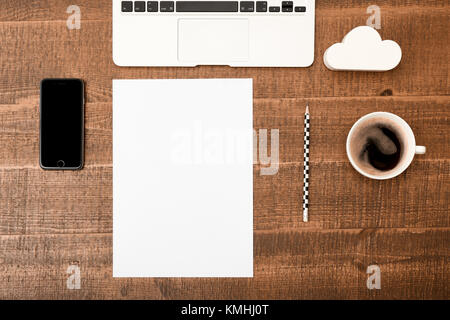 Office desk table. Top view with blank white paper, laptop, pencil and coffee  on wooden table background. Top view with copy space Stock Photo