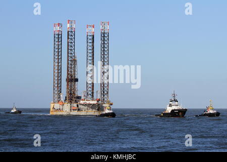 The offshore tug Pegasus towed the platform Paragon HZ1 on December 9, 2015 in the port of Rotterdam. Stock Photo