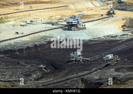 open pit coal mine with heavy machinery Stock Photo