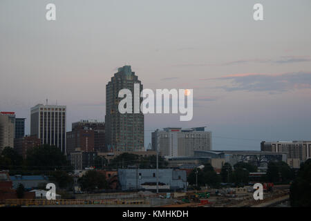 Full moon rising over the Raleigh, North Carolina skyline at dusk Stock Photo