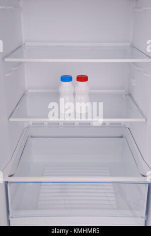 One yogurt in open empty refrigerator. Weight loss diet concept. Stock Photo