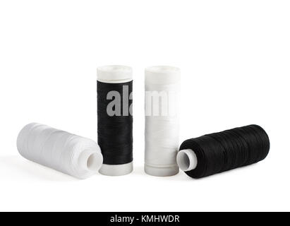 Four spools of black and white cotton threads isolated on white Stock Photo