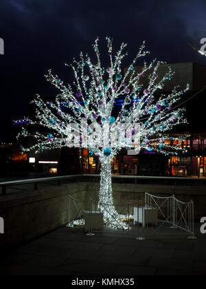 seasonal Christmas decorations on silver artificial tree in shopping centre at Salford, Manchester,UK Stock Photo