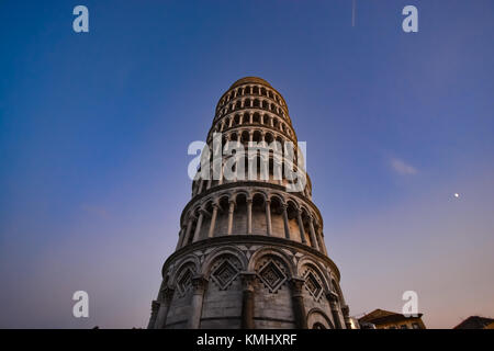 The leaning tower of Pisa Italy at the Piazza del Duomo as night falls.