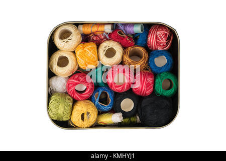 Path saved, isolated metal box full of colorful sewing threads on a white background Stock Photo