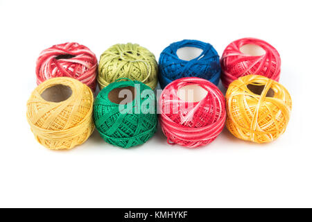 Set of eight colorful sewing threads on a white background Stock Photo