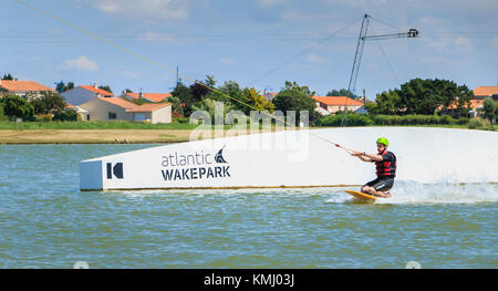 Aiguillon-sur-Mer, France, France - July 06, 2016 : installing a wake park during the 2016 season on the Lake of Aiguillon sur Mer, France - wakeboard Stock Photo