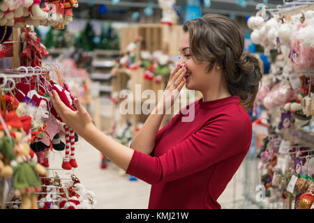 customer girl choosing gifts for Christmas and New Year Stock Photo
