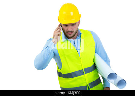 Angry upset young construction engineer yeling at the phone Stock Photo