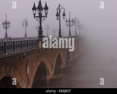 France. Nouvelle Aquitaine. Gironde. 'Pont de pierre' bridge in the fog, at Bordeaux.