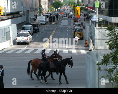 TORONTO - JUNE 23, 2010 - Police officers marching on the streets on horses during G20 Protest in Toronto, Ontario, Canada. Stock Photo