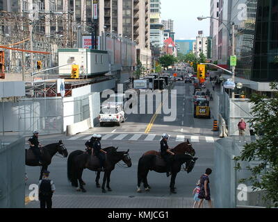 TORONTO - JUNE 23, 2010 - Police officers marching on the streets on horses during G20 Protest in Toronto, Ontario, Canada. Stock Photo