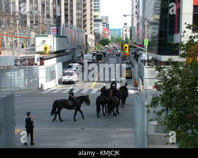 TORONTO - JUNE 23, 2010 - Police officers marching on the streets on horses during G20 Protest in Toronto, Ontario, Canada. Stock Photo