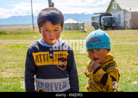 KEL-SUU, KYRGYZSTAN - AUGUST 13: Two young kids posing in a remote hamlet in Kyrgyzstan. August 2016 Stock Photo